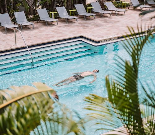 man swimming in pool